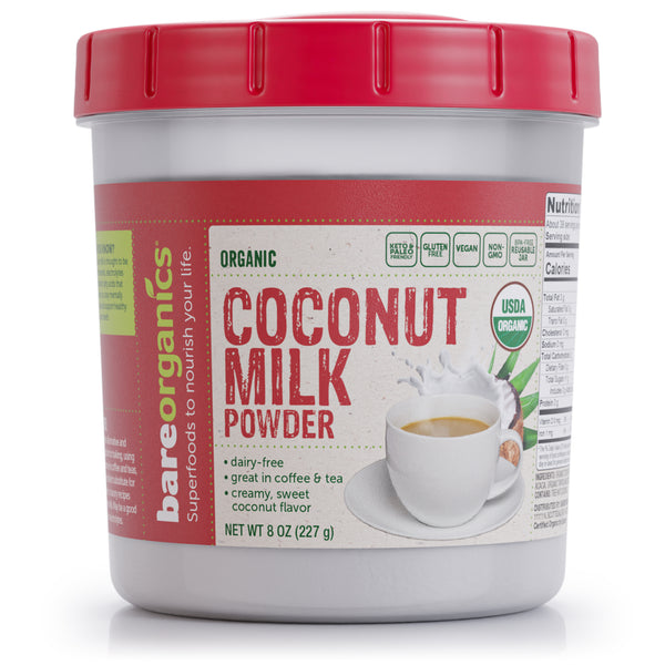 A container of BareOrganics Organic Coconut Milk Powder with a red lid, labeled as USDA Organic, vegan, gluten-free, and non-GMO. The container also includes an image of a cup with coffee creamer and provides nutritional information.